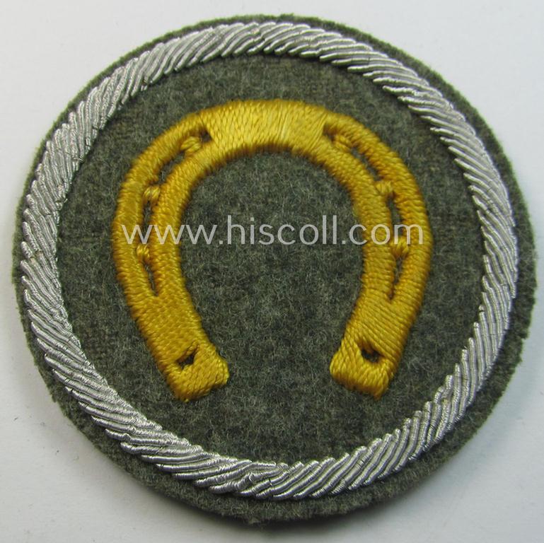 Attractive - and scarcely encountered! - WH (Heeres) hand-embroidered, trade- and/or special-career insignia (ie. 'Tätigkeitsabzeichen') as executed on a field-grey-coloured background, as was intended for a: 'geprüfter Hufbeschlagmeister'