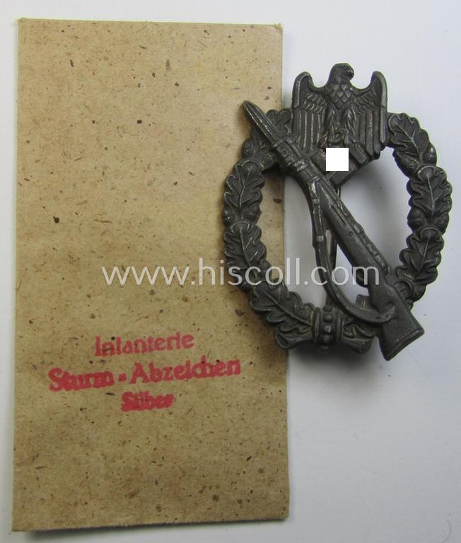 Neat, zinc- (ie. 'Feinzink'-) based example of an: 'Infanterie-Sturmabzeichen in Silber' being a maker- (ie. 'R.S.'-) marked example as was produced by the maker (ie. 'Hersteller') 'Rudolf Souval' and that came in its period 'Zellstoff' pouch