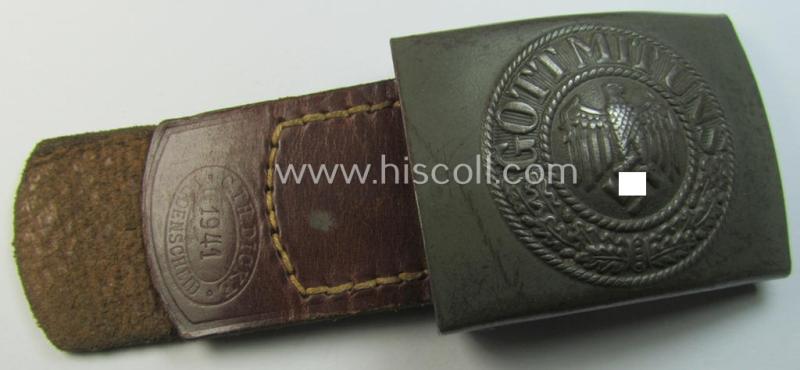 Attractive, WH (Heeres) field-grey-coloured- and/or steel-based belt-buckle, being a maker- (ie. 'C.T.H. Dicke'-) marked- and/or: '1941'-dated example that comes mounted on its leather-based tab and that comes in a moderately used- ie. worn, condition