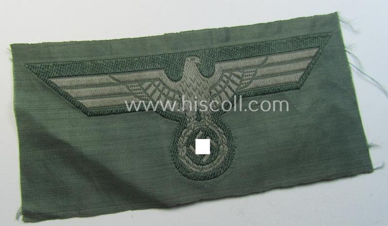 WH (Heeres) mid-war-period- and/or greyish-coloured breast-eagle of the so-called: 'M41'- (ie. 'M43'-) pattern 'Brustadler für Mannschaften u. Unteroffiziere') as executed in the neat 'BeVo'-weave pattern on a field-grey-coloured background