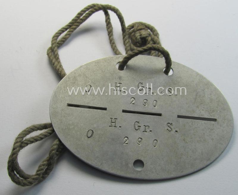 Attractive - and with certainty not that easily found! - aluminium-based, WH (Heeres) ID-disc bearing the clearly stamped unit-designation that reads: 'H.Gr.S.' and that comes mounted onto its period-cord as issued