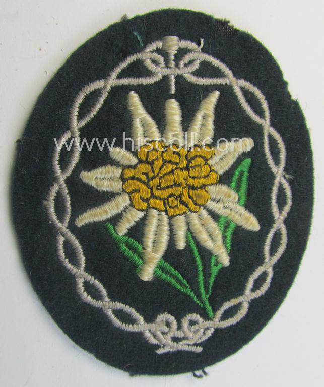 Truly used and/or tunic-removed, WH (Heeres) EM- (ie. NCO-) type, so-called: 'Edelweiss'-armpatch being a machine-embroidered example as was executed on darker-green wool as was specifically intended for usage by the: 'Gebirgsjäger-Truppen'