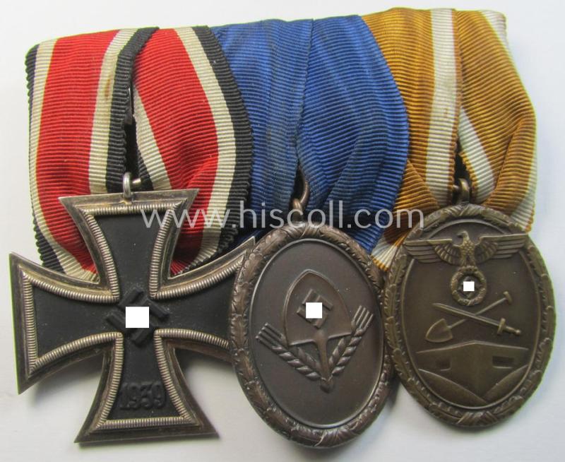 Attractive, 3-pieced WH (Heeres o. KM) medal-bar (ie. 'Ordenspange') showing resp. an: 'EK II. Kl.', a: RAD (ie. 'Reichsarbeitsdienst'): 'DA 4. Stufe für Männer' and a: 'Westwall'-medal