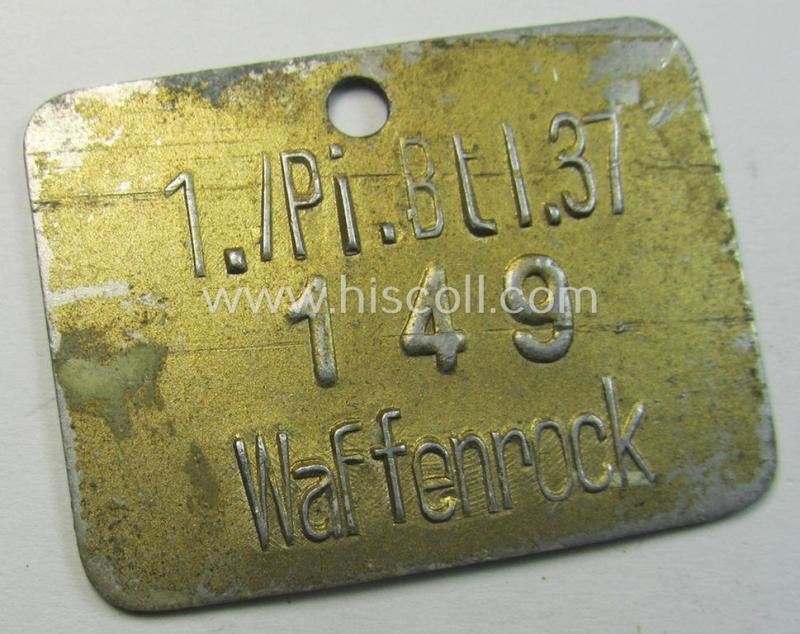 Very unusual, golden-toned and/or aluminium-based equipment- ie. wash-tag (ie. 'Wasch-Marke') bearing the unique numeral: '149' and superimposed text: '1./Pi.Btl. 37 - Waffenrock'