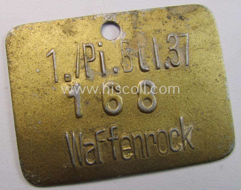Very unusual, golden-toned and/or aluminium-based equipment- ie. wash-tag (ie. 'Wasch-Marke') bearing the unique numeral: '168' and superimposed text: '1./Pi.Btl. 37 - Waffenrock'