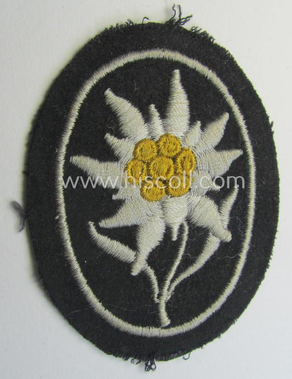 Waffen-SS-pattern, black-coloured sleeve-insignia (ie. 'Ärmelabzeichen') depicting an: 'Edelweiss'-flower as used by the various 'Gebirgsjäger'- (ie. mountain-troops-) related divisional-staff