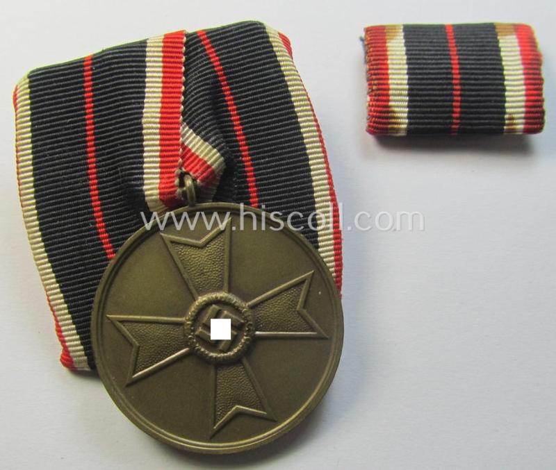 Attractive - and rarely found! - example of an: 'Einzelspange' (ie. single-pieced medal-bar) showing a: 'Kriegsverdienstmedaille 1939' (or: war-merits-medal) being a neat 'Buntmetall'-based specimen that comes with its accompanying ribbon-bar