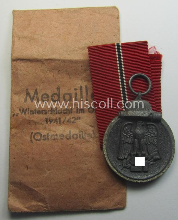 Neatly maker- (ie. '19'-) marked medal: 'Winterschlacht im Osten 1941/42' that came stored in its period pouch by the company: 'E. Ferd. Wiedmann'