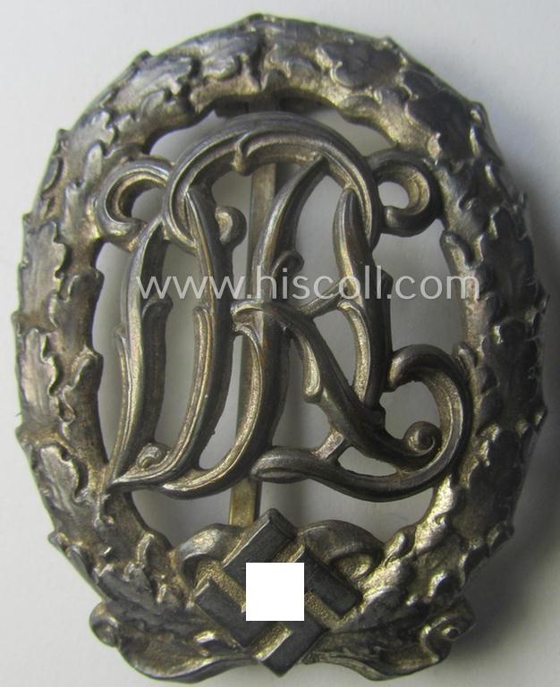 'Reichssportabzeichen DRL in Silber' (or: DRL sports'-badge in silver) being a just moderately worn- ie. used example that is nicely maker- (ie. 'Wernstein - Jena'-) marked on its back