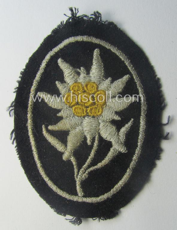 Neat - and I deem truly used and/or worn! - Waffen-SS-pattern, black-coloured sleeve-insignia (ie. 'Ärmelabzeichen') depicting an: 'Edelweiss'-flower as used by the various 'Gebirgsjäger'- (ie. mountain-troops-) related divisional-staff
