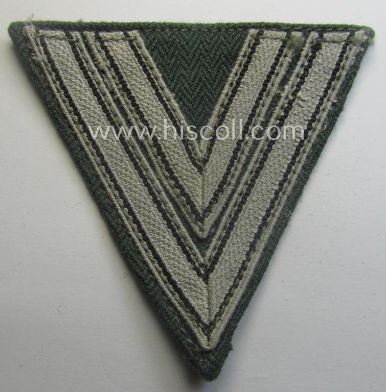 WH (Heeres ie. Waffen-SS) 'Armwinkel' (or: arm-chevron) as was executed on a greenish-coloured- and/or 'HBT'-like (ie. 'Drillich'-) based background as was specifically intended for usage by an: 'Obergefreiter' (ie. 'SS-Rottenführer')