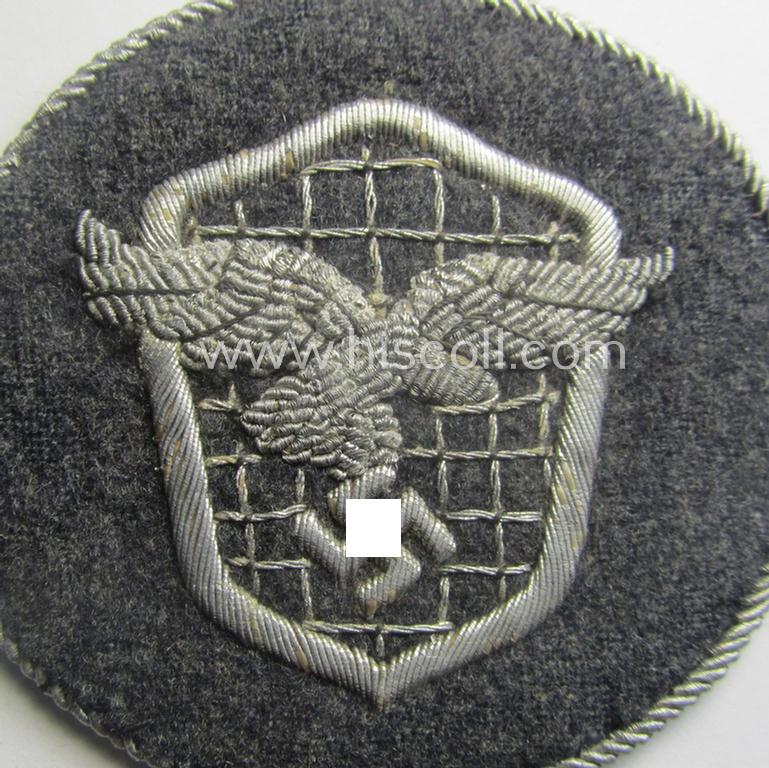 Superb - and actually rarely encountered! - example of a WH (Luftwaffe) neatly hand-embroidered, trade- ie. special-career-patch (ie. 'Tätigkeitsabzeichen') having a silverish-grey-toned 'Kordel' attached as was intended for: 'LW-Kraftfahrpersonal'