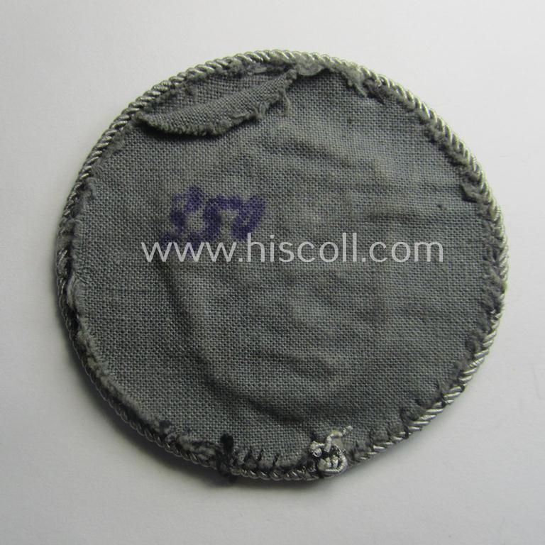 Superb - and actually rarely encountered! - example of a WH (Luftwaffe) neatly hand-embroidered, trade- ie. special-career-patch (ie. 'Tätigkeitsabzeichen') having a silverish-grey-toned 'Kordel' attached as was intended for: 'LW-Kraftfahrpersonal'