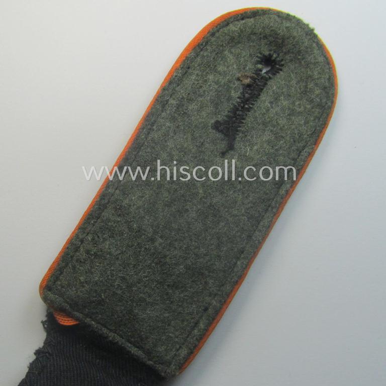 Single, Waffen-SS, EM-type shoulderstrap as piped in the bright-orange-coloured branchcolour as was intended for usage by an: 'SS-Mann' who served within the: 'SS-Feldgendarmerie-Trpn.'